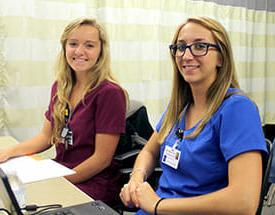 students in scrubs at computer